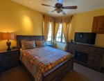 The second bedroom features a queen bed and a flat screen tv.